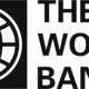 Black and white logo for The World Bank featuring a circular globe icon with latitude and longitude lines inside a black square on the left and the words THE WORLD BANK in a bold sans-serif font stacked on the right.